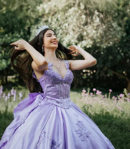 Quinceañera in a lavender gown celebrating outdoors