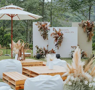Outdoor event lounge set with a floral backdrop